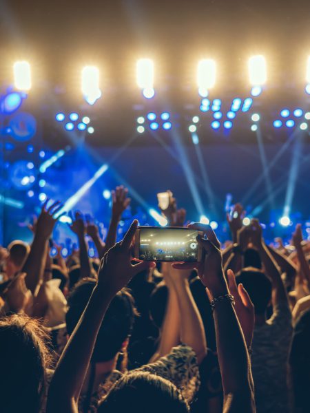 Concert crowd of Music fanclub hand using cellphone taking video record or Live stream with superstar songer, happy new year, christmas and festival concept